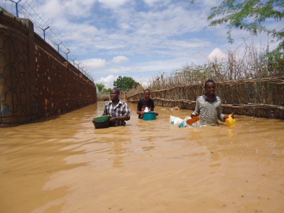 Moradores de Beletweyne, na Somália, atravessam a água barrenta de enchente — Foto: Oxfam East Africa/Flickr/HARDO