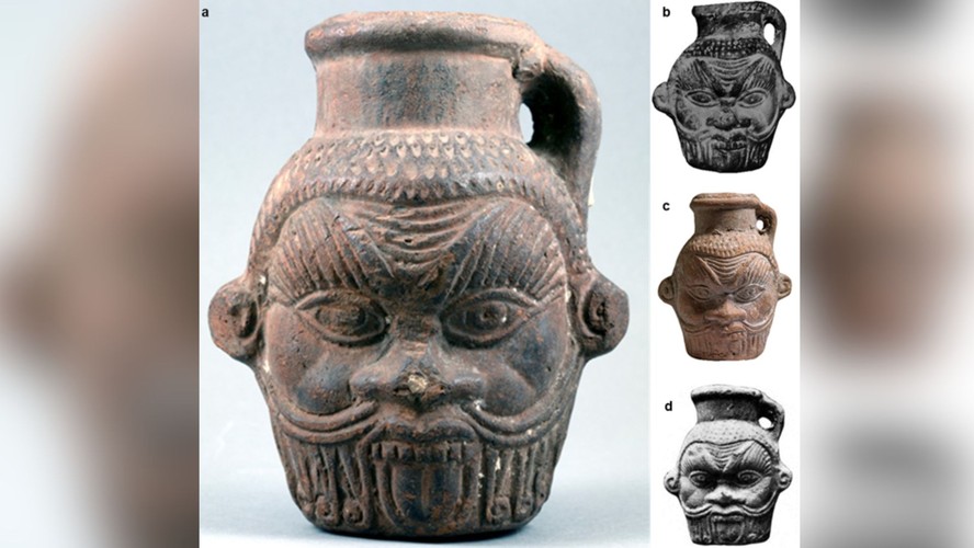 Pote de bebida egípcio em forma da cabeça do deus Bes datado do período ptolomaico-romano