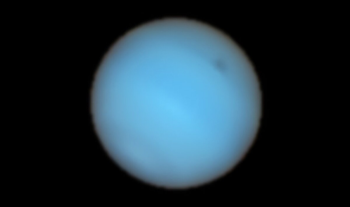 A mysterious dark spot on the planet Neptune appears from Earth for the first time  space