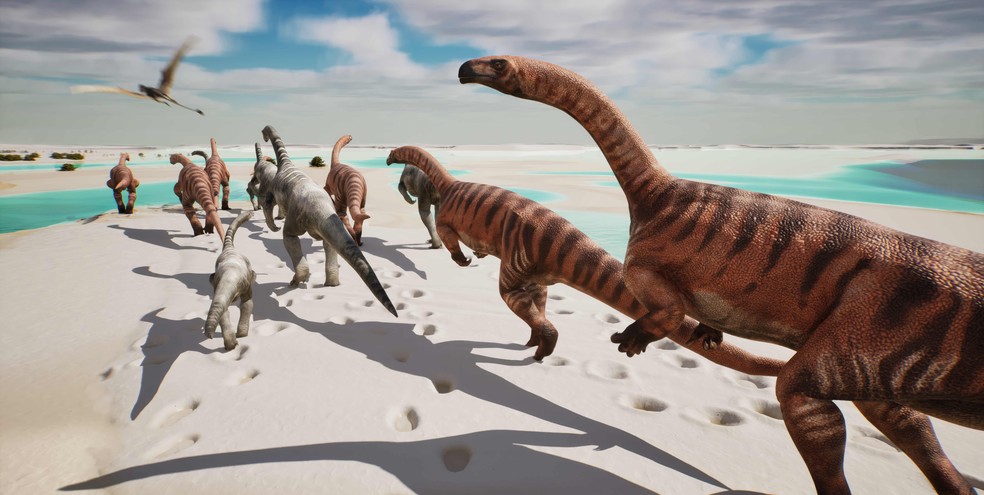 Reconstrução paleoartística de como poderia ser o ambiente há cerca de 210 milhões de anos,  hoje preservado nas rochas do Vale de Fraele (Parque do Stelvio). Ao longo da costa do Oceano Tétide, um grupo de dinossauros prosauropodes caminha sobre uma extensa planície carbonática lamacenta, durante a maré baixa . No rebanho também há exemplares jovens, como indicam algumas pegadas fósseis de dimensões reduzidas. Machos e fêmeas são aqui imaginados com cores diferentes — Foto: Fabio Manucci, Arch. PaleoStelvio (PNS, MSNM, SABAP CO-LC)